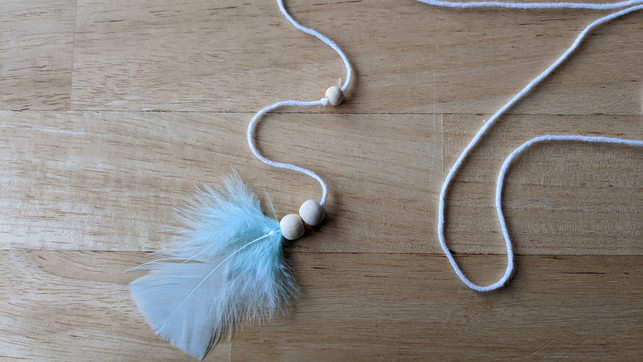 fertige-die-schnuere-mit-federn-und-bommeln-an-marie-theres-bauer-utopia-220308_download Fertige die Schnüre mit Federn und Bommeln an.