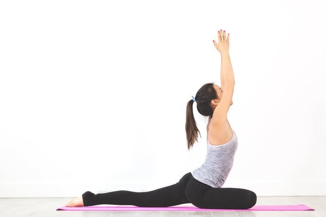 The pigeon is a yoga exercise that you can also do while sitting on a chair.