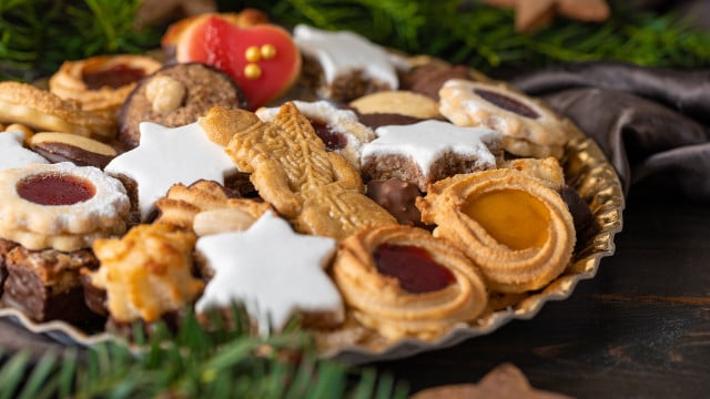Various Christmas Cookies on a Plate on a wodden table ochsenaugen