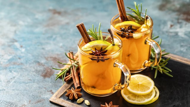 Hot drink cocktail for New Year, Christmas, winter or autumn holidays.
Toddy. Mulled pear cider or spiced tea or grog with lemon, pear, cinnamon, anise, cardamom, rosemary. Hot Toddy