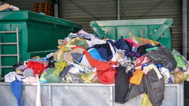 Used clothes at recycling utility. Circular economy concept. Kleidung, vernichtet, Corona, Greenpeace
