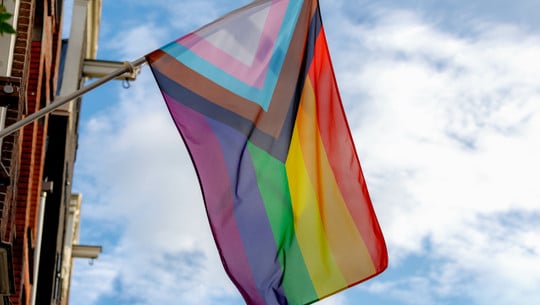 Progress pride flag (new design of rainbow flag) waving in the a Progress-Pride-Flagge